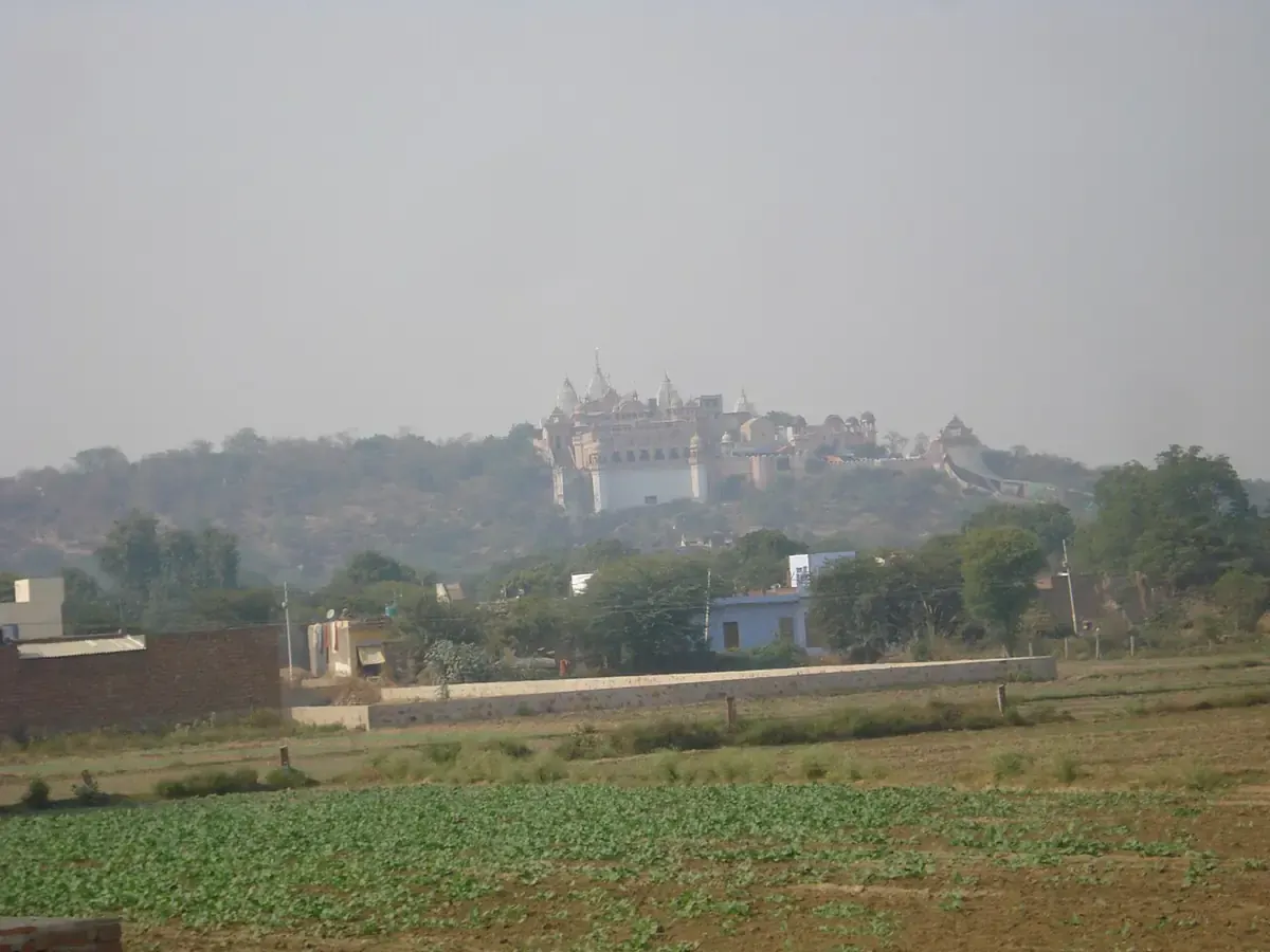 Shriji's temple on its hill, seen across the fields